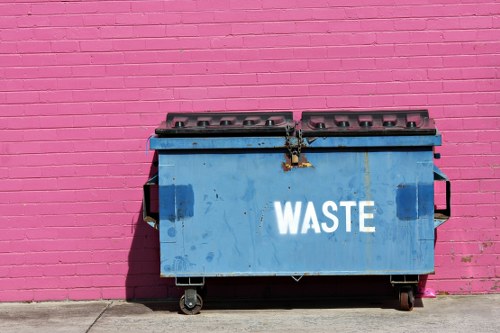 Skips at a recycling yard in Hornsey with sustainability signage