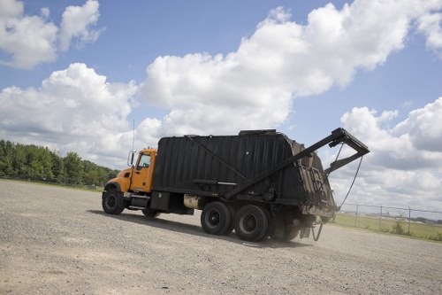 Low-carbon vans loading skips for eco-friendly collections